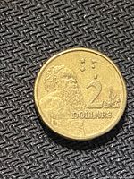 Reverse of 1998 Australian $2 coin showing Aboriginal elder, Southern Cross, denomination