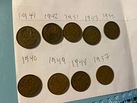 Nine Canadian pennies laid out obverse and reverse showing dates