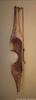 Front view of weathered wooden nautical wall hanging with rope and metal hooks