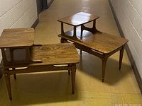 Two Chesley two-tier end tables positioned in hallway showing overall design