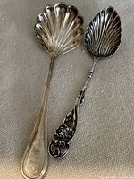 Full view of both sterling silver spoons showing size difference and design