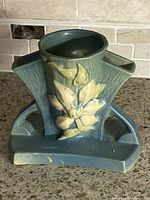 Front view showing clematis relief flower, glaze colour, overall form