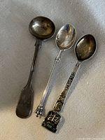 Front view of three spoons showing bowls and handles