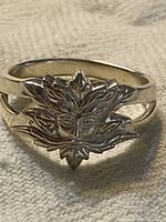 Front view of sterling silver ring showing Green Man leaf face design