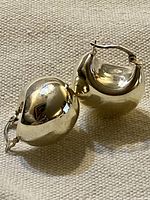 Front view of both domed sterling silver hoop earrings showing latch closures