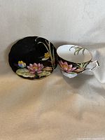 Teacup and saucer front view showing floral motif and gold trim