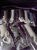 Eight sealed fabric cylinder catnip toys displayed on surface