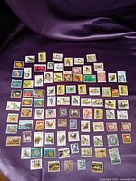Full layout of 90 assorted Australian stamps on purple background