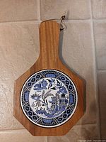 Front view of board showing ceramic tile insert and handle