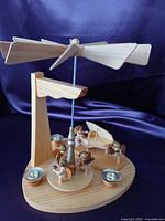 Full view of wooden Christmas pyramid showing rotor, spindle, angels, candle holders