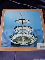 front of box showing assembled 3-tier stand