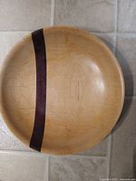 Top view of light maple plate showing dark inlay band