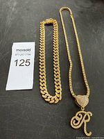 Full view of both necklaces laid flat