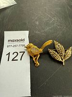 Both brooches side by side showing scale