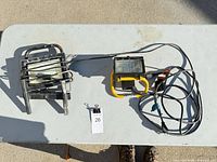 Top view of two corded halogen work lights on table