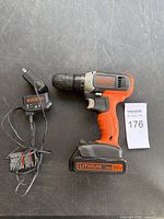 Front view of drill with attached battery and separate charger