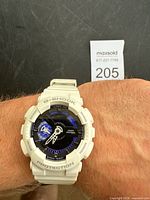 Full view of watch on wrist showing face and bezel text