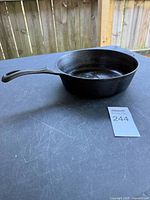 Side view of cast iron skillet showing handle and interior