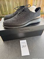 Side view of both shoes on Cole Haan box