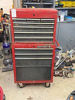 Front view of red Craftsman rolling tool chest showing all drawers and casters
