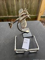 Brass airplane sculpture and metal eyeglasses together on table