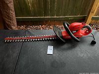 Full view of Black & Decker hedge trimmer on table showing blade and body