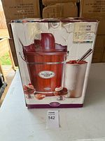 Retail box showing Nostalgia electric ice cream maker, front graphics and branding