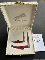 Gift box opened showing two pocket knives
