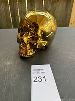 Front left view of metallic gold skull