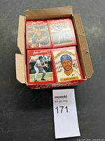 Overall view of open box showing stacks of red-border 1990 Donruss baseball cards