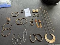 Full layout of all jewelry pieces on black surface