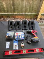 Group shot showing all items including wheel chocks, drill, level, headlamp, first aid kit, locks
