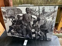 Front view of black & white photo print depicting five boys on vintage car