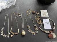 Overview of entire jewelry lot on black surface
