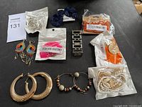 Group shot of entire jewelry lot displaying packaged and loose items