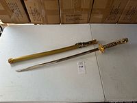 Full view of sword and scabbard on table