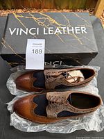 Shoes inside original Vinci Leather box with lot tag visible