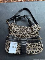 Front view of Michael Kors monogram canvas shoulder bag