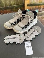 Pair of Nike Air Money sneakers with detached shrouds and size tag