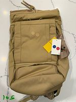 Front view of khaki Pinqponq Blok Medium backpack with tags