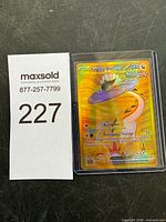 Front view of Raging Bolt ex gold secret rare card next to lot number card