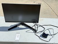 Front view of Samsung 22-inch monitor on stand with power adapter and cable visible
