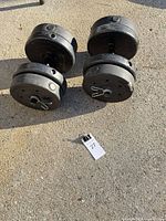 Four plate stacks mounted on two dumbbell bars