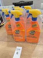 Six sealed Zep degreaser bottles standing on table