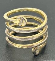 Oblique view showing four-row coil and stone-set terminal ends