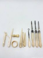 all eleven bone-handled sewing tools laid out side by side