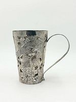 Side view showing dragon repoussé and handle