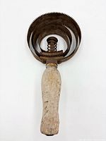 Front view showing concentric serrated rings and handle attachment