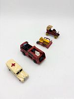 Group of four die-cast vehicles on white background