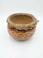 Front three-quarter view showing painted band and coiled rim